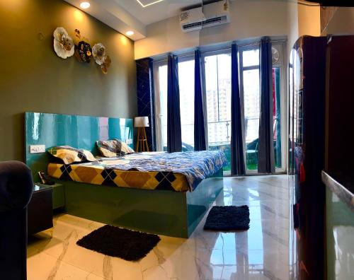 a bedroom with a bed with a fish tank on the wall at Zen studio in Ghaziabad