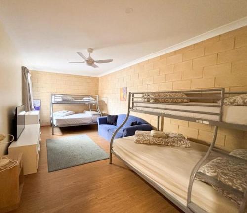 a room with two bunk beds and a couch at Things of Stone and Wood in Lancelin