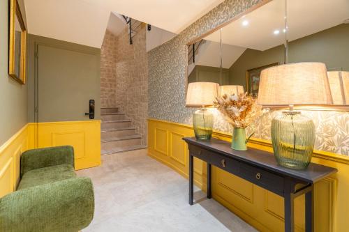 a room with a table and a chair and a mirror at La Réserve de Salon de Provence in Salon-de-Provence