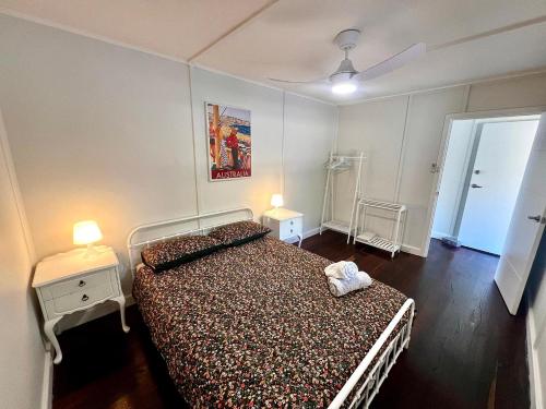 a bedroom with a bed and two night stands and two lamps at Playgrounds in Lancelin