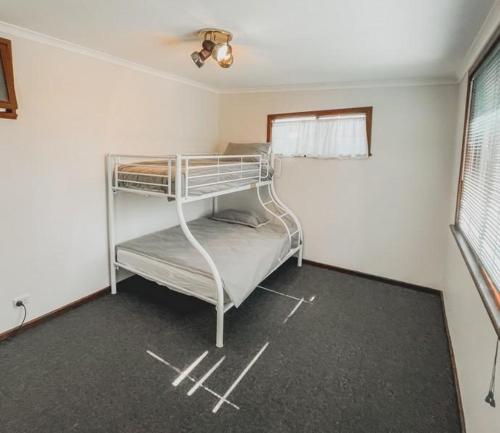 a bedroom with two bunk beds in a room at The Newby in Lancelin