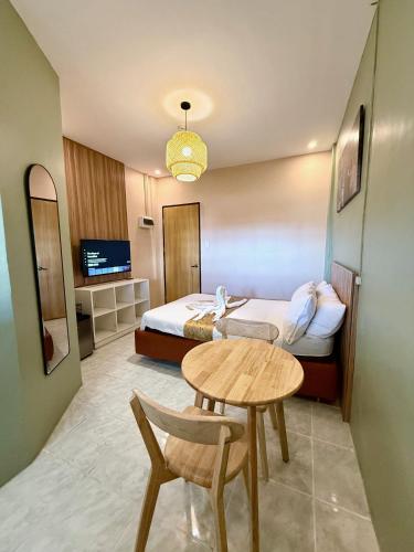 a hotel room with a bed and a table and a table at ABC Homes PH in Olongapo
