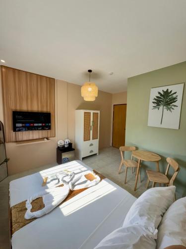 a hotel room with a bed and a table at ABC Homes PH in Olongapo