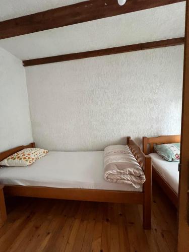 two bunk beds in a room with wooden floors at Shpella e Madhe - Villa e Gurit in Boge