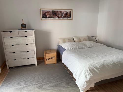 a bedroom with a bed and a dresser at Lorenzo -Appartment-04 in Burglengenfeld