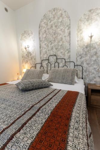 a bedroom with a large bed with two pillows at REDROOF country house hotel in Goris