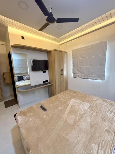 a bedroom with a large bed with a ceiling fan at Hotel Highway Nest Igatpuri in Ghoti Budrukh