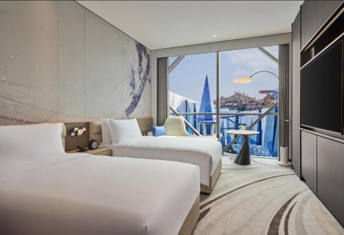 a hotel room with two beds and a large window at Crowne Plaza Shanghai Snow World by IHG in Shanghai