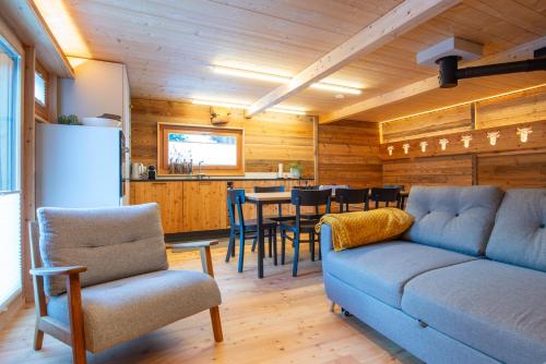 a living room with a couch and a table with chairs at Chalet Himmel - Top renoviertes Walliserhaus in Biel VS in Ritzingen