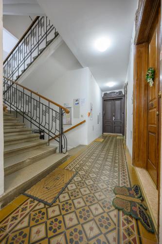 a hallway with stairs and a tile floor at Quiet & Comfortable Studio Apartment in Vienna in Vienna