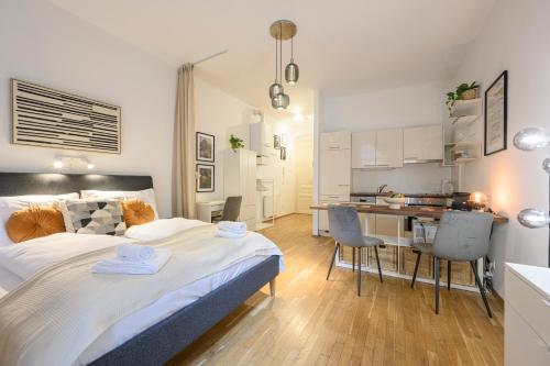 a bedroom with a large bed and a kitchen at Quiet & Comfortable Studio Apartment in Vienna in Vienna