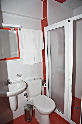 a bathroom with a white toilet and a sink at Hotel Serdica in Silistra