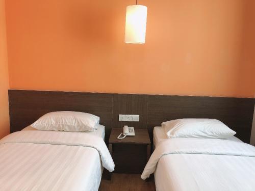Кровать или кровати в номере GPI HOTEL Bentong