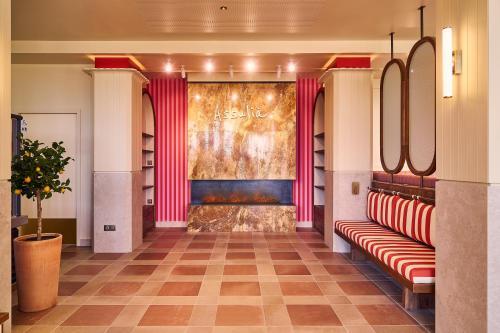 a dressing room with red chairs and a wall with a mirror at Best Western Plus Ajaccio Amirauté in Ajaccio