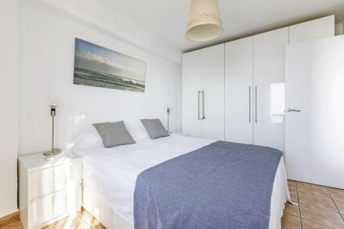 a white bedroom with a bed and white cabinets at Sea View & Beach View Appartement Torre Del Mar in Torre del Mar