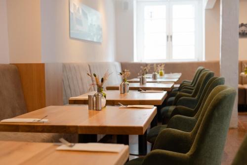 a row of tables and chairs in a restaurant at Hanse House Wismar in Wismar