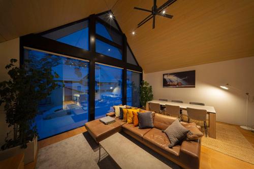 a living room with a couch and a table at Prominence by The Hakuba Collection in Hakuba
