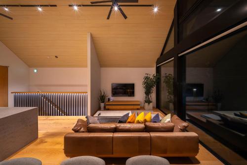 a living room with a couch and a bed at Prominence by The Hakuba Collection in Hakuba