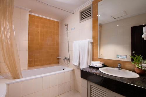a bathroom with a bath tub and a sink at Oak Ray Colombo City Hotel in Colombo