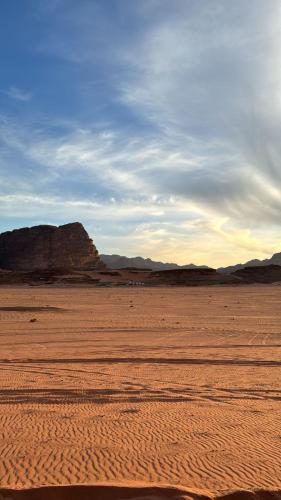 an empty desert with mountains in the background at Wadi Rum Magic Camp in Wadi Rum