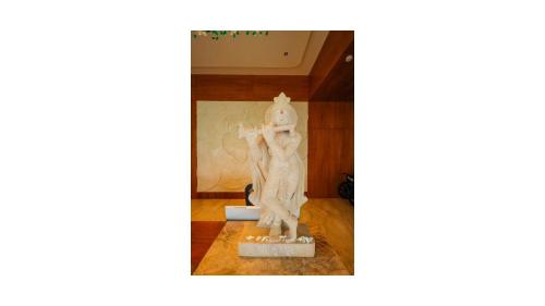 a statue of a woman standing in a room at Araiya Gir,A Mavintara Resort in Chitrāwal
