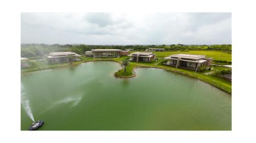 an aerial view of a lake with a boat in it at Araiya Gir,A Mavintara Resort in Chitrāwal