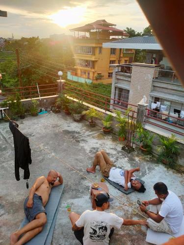 a group of men sitting on the ground at Oktang Home in Siliguri