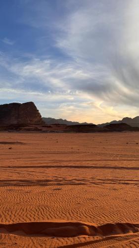 a view of a desert with mountains in the background at Wadi Rum Magic Camp in Wadi Rum