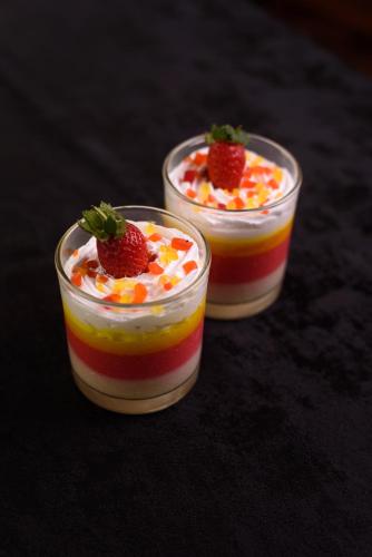 two plastic cups of dessert with strawberries in them at Oak Ray Colombo City Hotel in Colombo