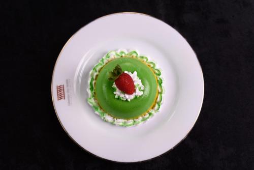 a green dessert with a strawberry on a white plate at Oak Ray Colombo City Hotel in Colombo