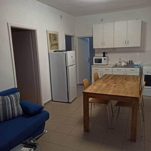 a kitchen with a table and a kitchen with a refrigerator at Barackvirág in Balatongyörök