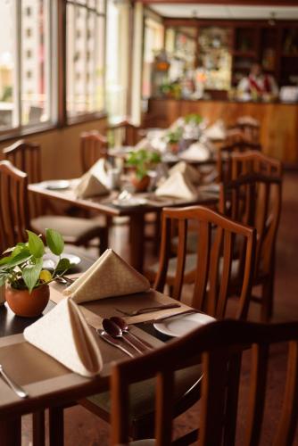 a row of tables in a restaurant with chairs and tablesearcher at Oak Ray Colombo City Hotel in Colombo
