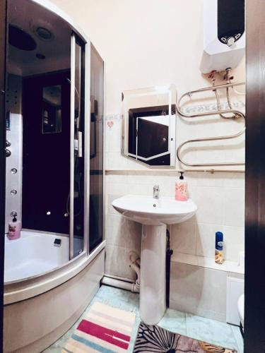 a small bathroom with a sink and a shower at Международный Аэропорт Алматы Апартаменты "100 метров" in Almaty
