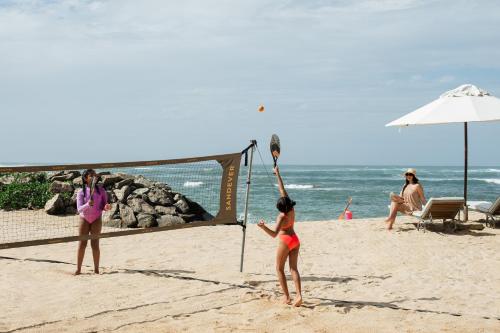a group of people playing volleyball on the beach at Cape Weligama - Relais and Chateaux in Weligama