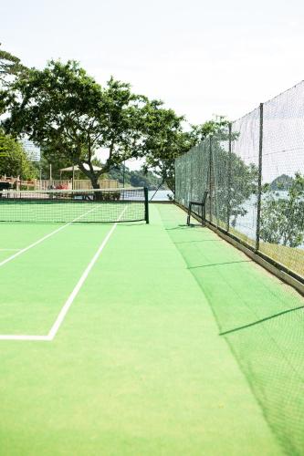 a tennis court with a net on a court at The Osborne Hotel in Torquay