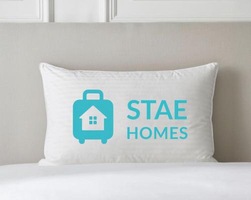 a pillow with a suitcase and a tag with a house at PLEASANT View Impressive Home In Stunning Rhondda Valley By Staystaycations in Pontypridd