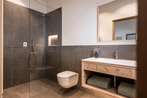 a bathroom with a toilet and a sink and a shower at Florerhof in Schenna