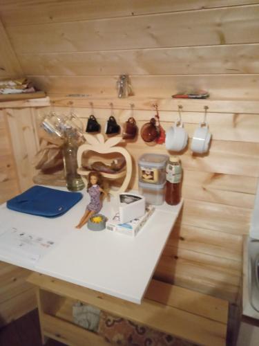 a doll sitting on a table in a room at Kota de choux in Choux