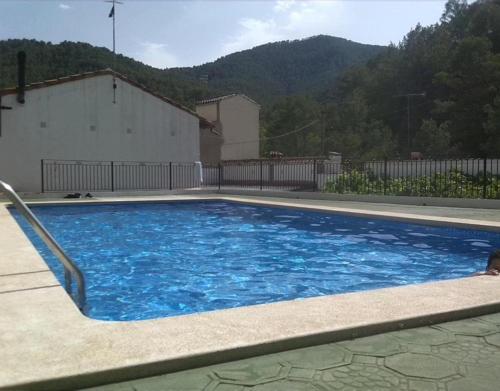 a large blue swimming pool in a house at Casa Rural de Benitandus in Alcudia de Veo