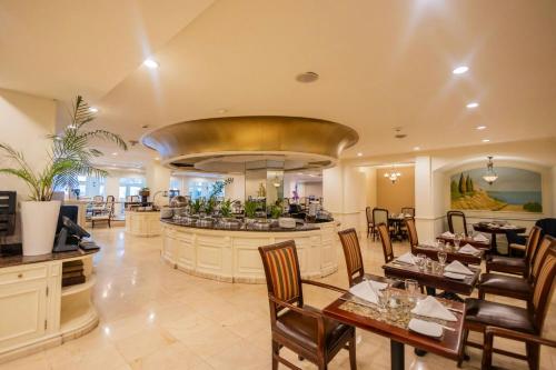 a restaurant with a bar with tables and chairs at The Westin Camino Real, Guatemala in Guatemala