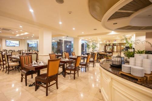 a restaurant with tables and chairs and a bar at The Westin Camino Real, Guatemala in Guatemala