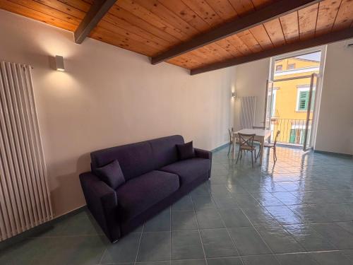 a living room with a couch and a table at Il Balcone sul Castello in Ischia