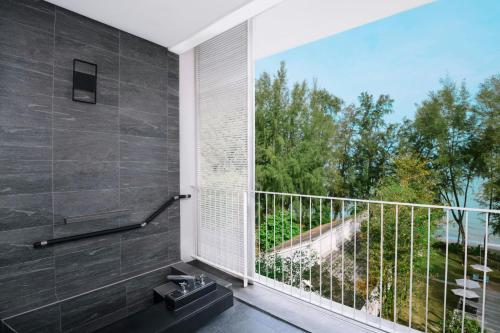 a bathroom with a sink and a large window at Lone Pine, Penang, a Tribute Portfolio Resort in Batu Ferringhi