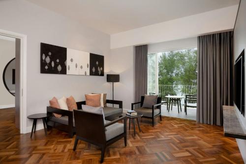 a living room with a couch and a table at Lone Pine, Penang, a Tribute Portfolio Resort in Batu Ferringhi