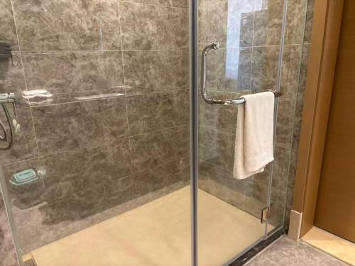a shower with a glass door in a bathroom at TheBess Hotel Tokyo is located adjacent to Singapore and offers a sea viewIt is a family business smart room with the sea view of Princess Bay富力公主湾 in Johor Bahru