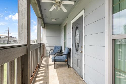 a porch with two chairs and a ceiling fan at Baronne Street Spacious and Fully Furnished Condo in New Orleans