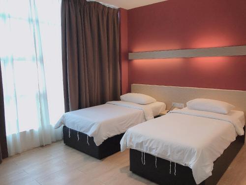 Postel nebo postele na pokoji v ubytování Tras Mutiara Hotel Bentong