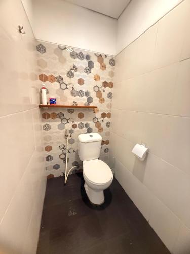 a bathroom with a white toilet in a room at Home Stay Room in Bali Near Sanur Beach in Sanur