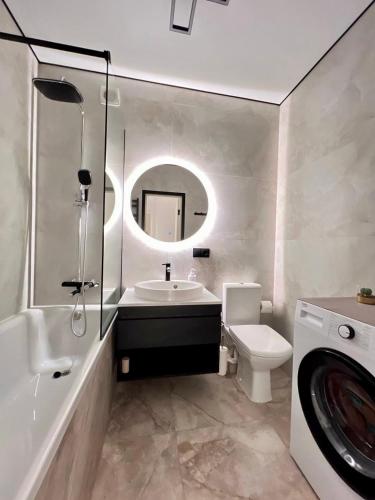 a bathroom with a sink and a toilet and a mirror at Яровиця 9 новобуд in Lutsk