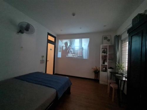 a bedroom with a bed and a wall with a picture at Paradies Homestay in Hue